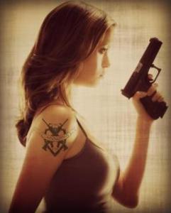 girl with tatto and gun